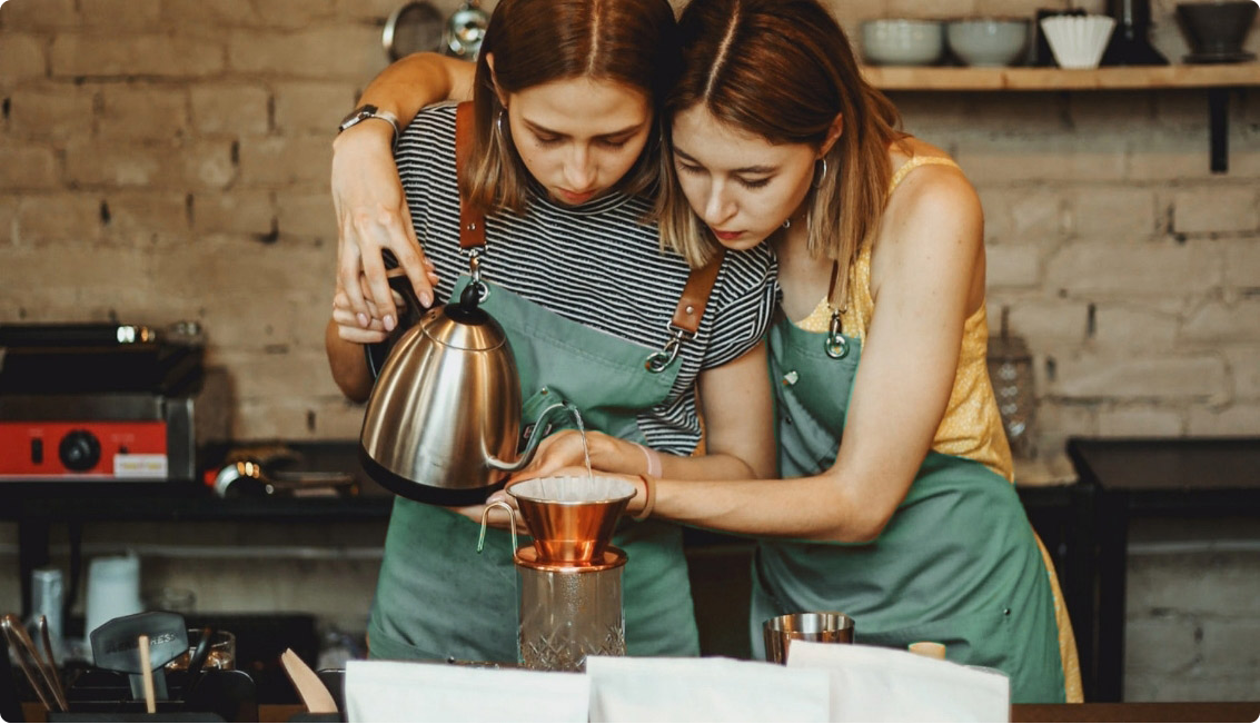 two girls make a coffee